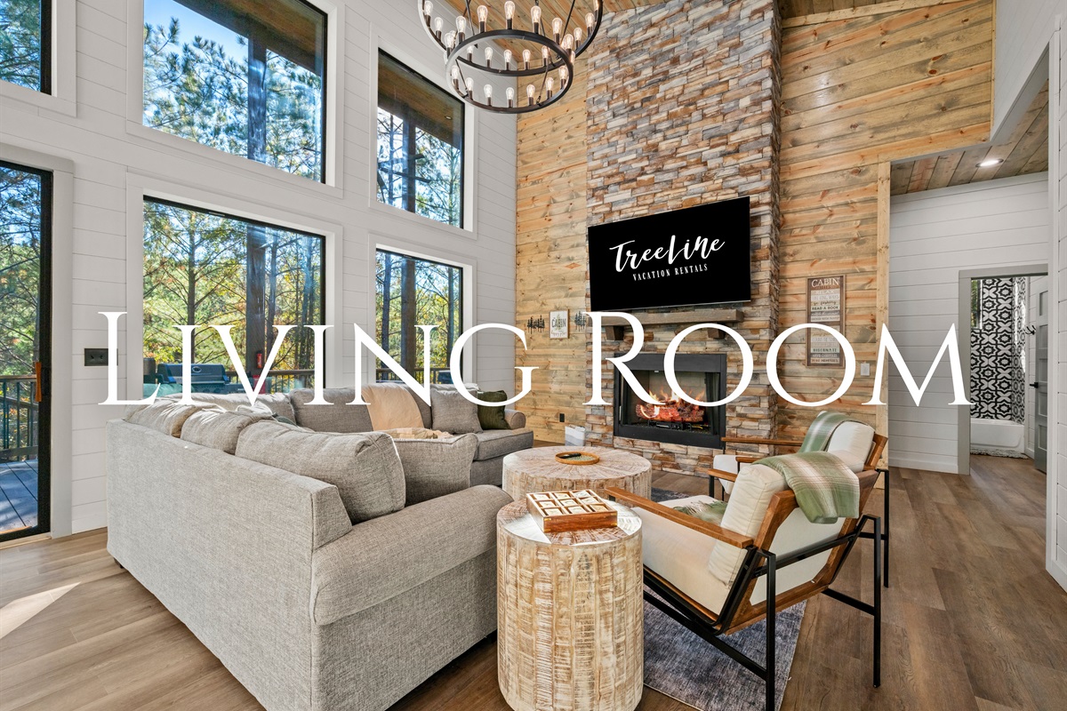Bright windows and plush seating make this living room an inviting space to gather, play games, or relax after a day of exploring.