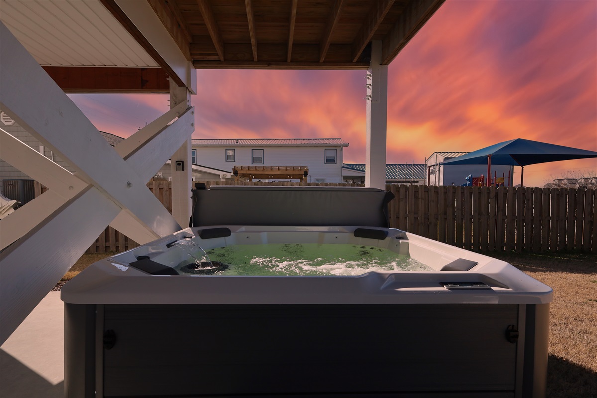 Bubbling to perfection- Plenty of room for everyone in this eight person hot tub located on the ground floor, nestled behind the car port within the fenced in yard for increased privacy