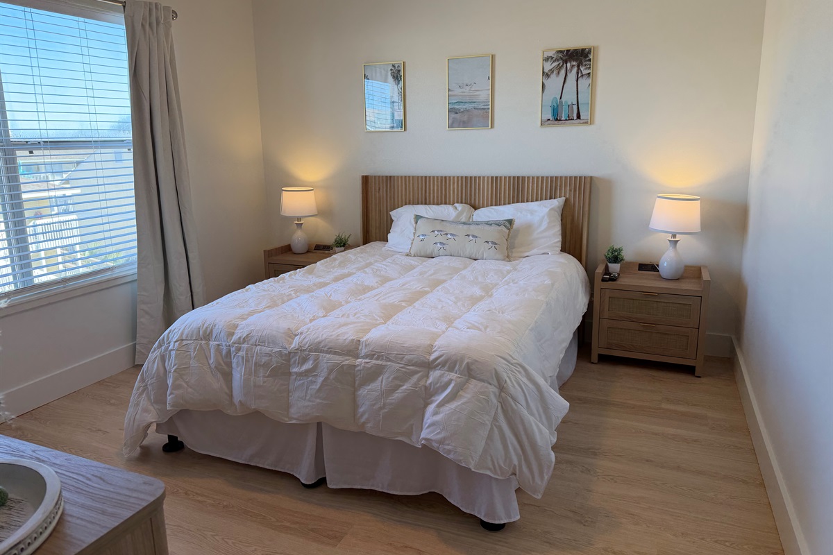 Guest bedroom with nightstands that have build-in charging capability for your Apple devices and plenty of storage room!