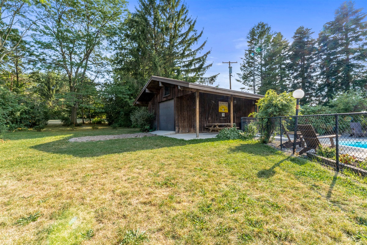 Enjoy wide-open space and privacy with a rustic barn backdrop and a fenced poolside oasis.