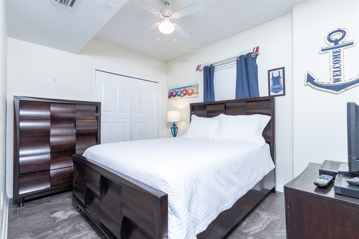 Bedroom 2 with queen bed, ceiling fan and TV