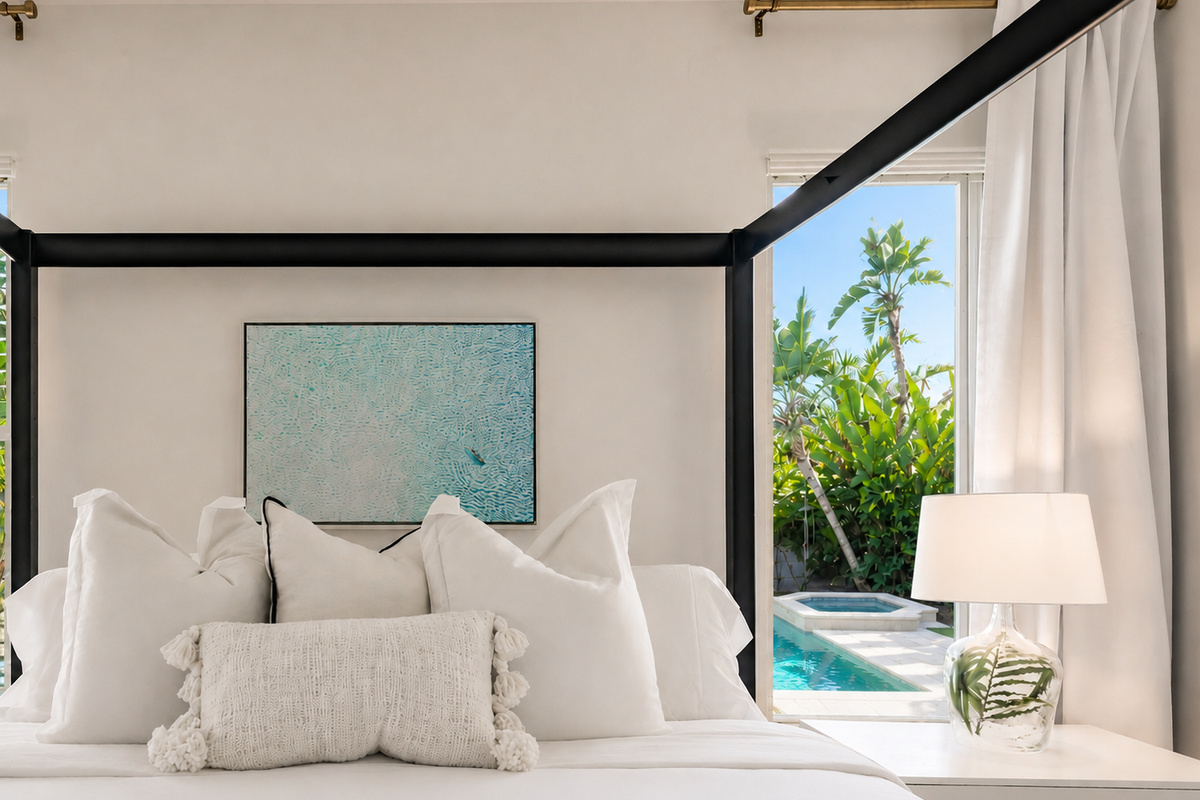 Wake up in the main king suite with views of the pool and slider to the screened lanai