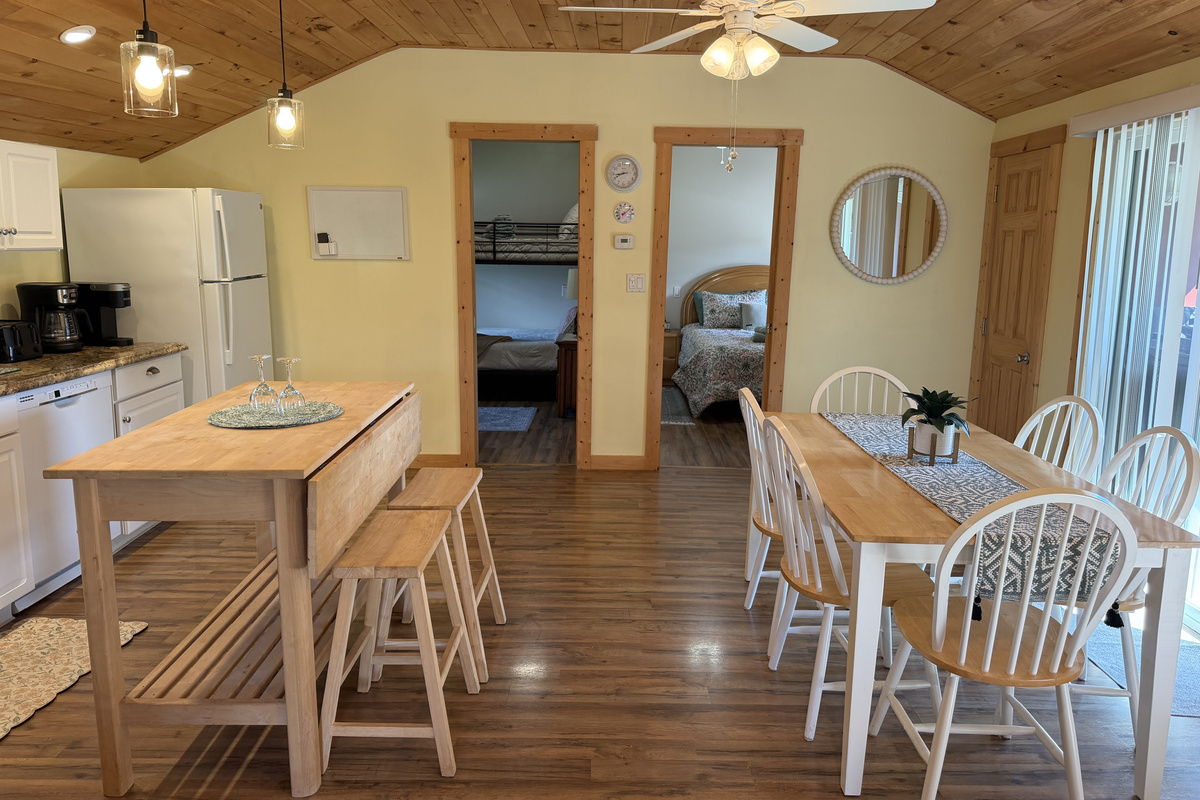 Dining and kitchen with bedrooms beyond