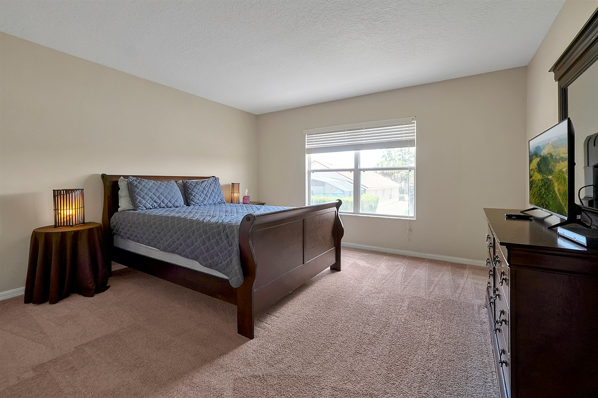 Retreat to a private escape upstairs: a comfortable queen bedroom perfect for quiet downtime, complete with a dedicated flat-screen TV 