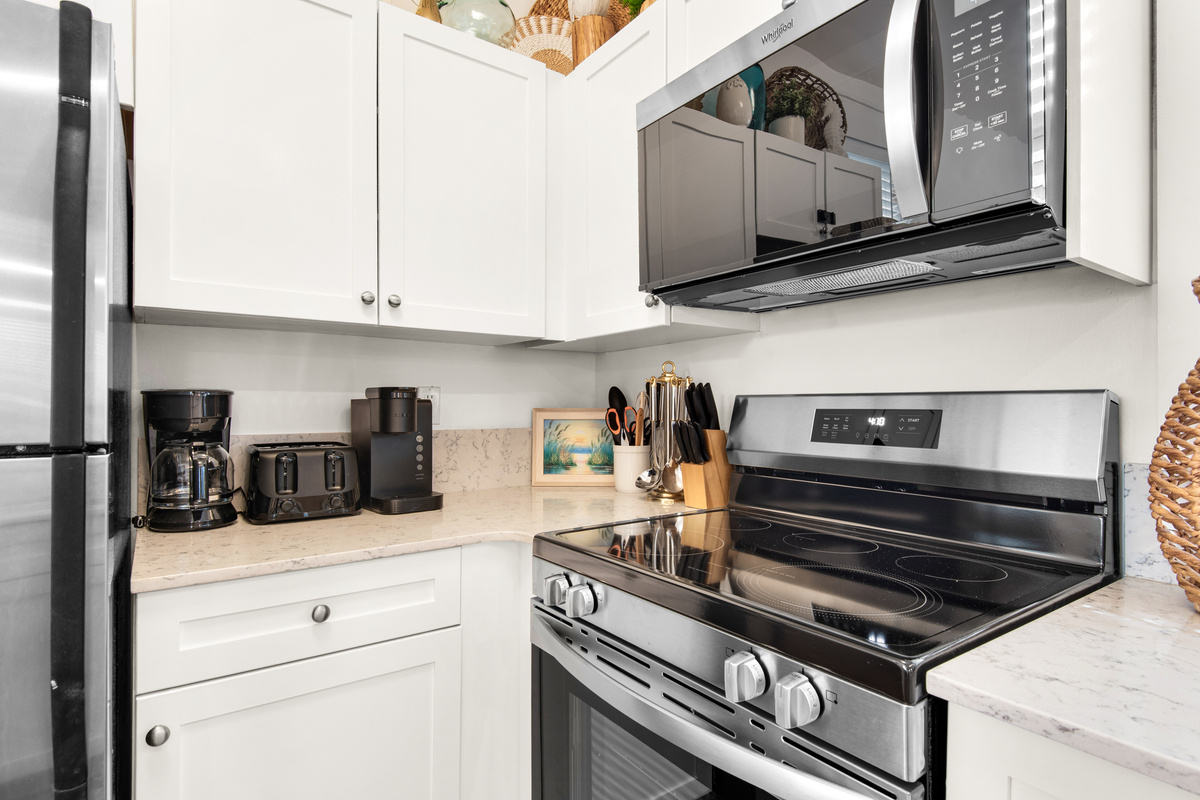 Seagrove Bungalow 103 kitchen appliances: stove, oven, microwave and countertop coffee station.