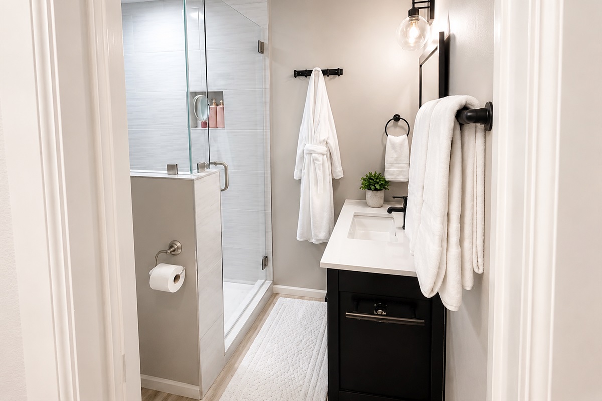 Bright and beautifully updated bathroom featuring a sleek walk-in shower and luxury touches throughout