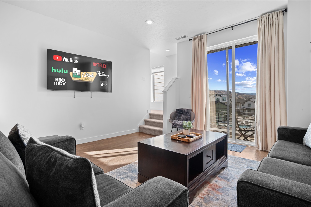 Comfortable living room with large sofa and Smart TV.