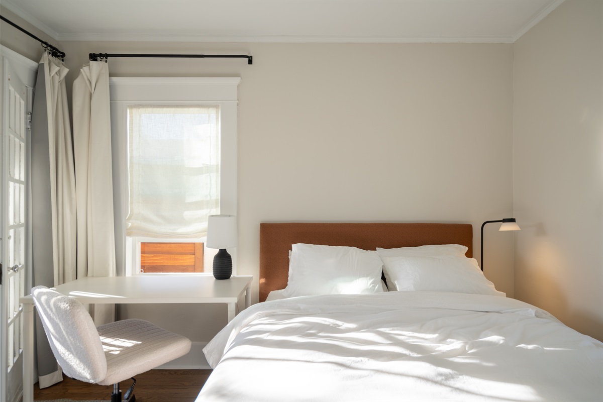 The second bedroom includes a queen bed, private entrance, and worktable.