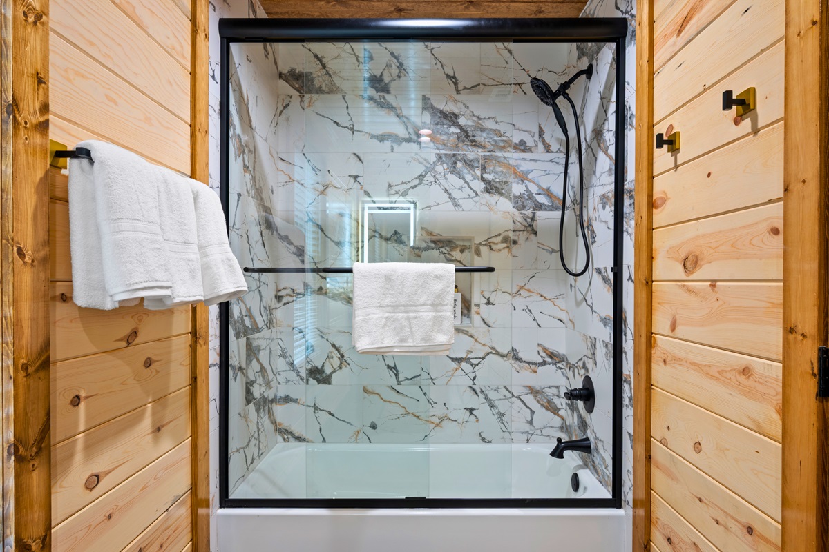 A stylish tub and shower combination with bold tile adds both function and a touch of character to the bathroom.