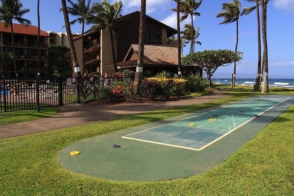 Two lawn shuffle board courts next to pool at the Papakea