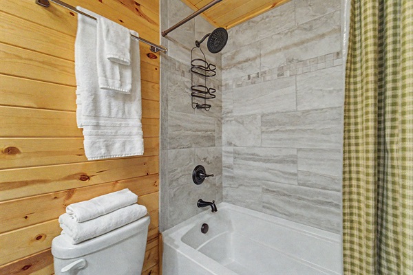 Tub/Shower Combo with Tiled Finish, Accompanied by Luxury Bath Linens