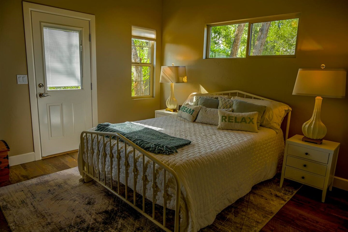 Guest Bedroom with Queen Bed and direct access to outdoor living space.