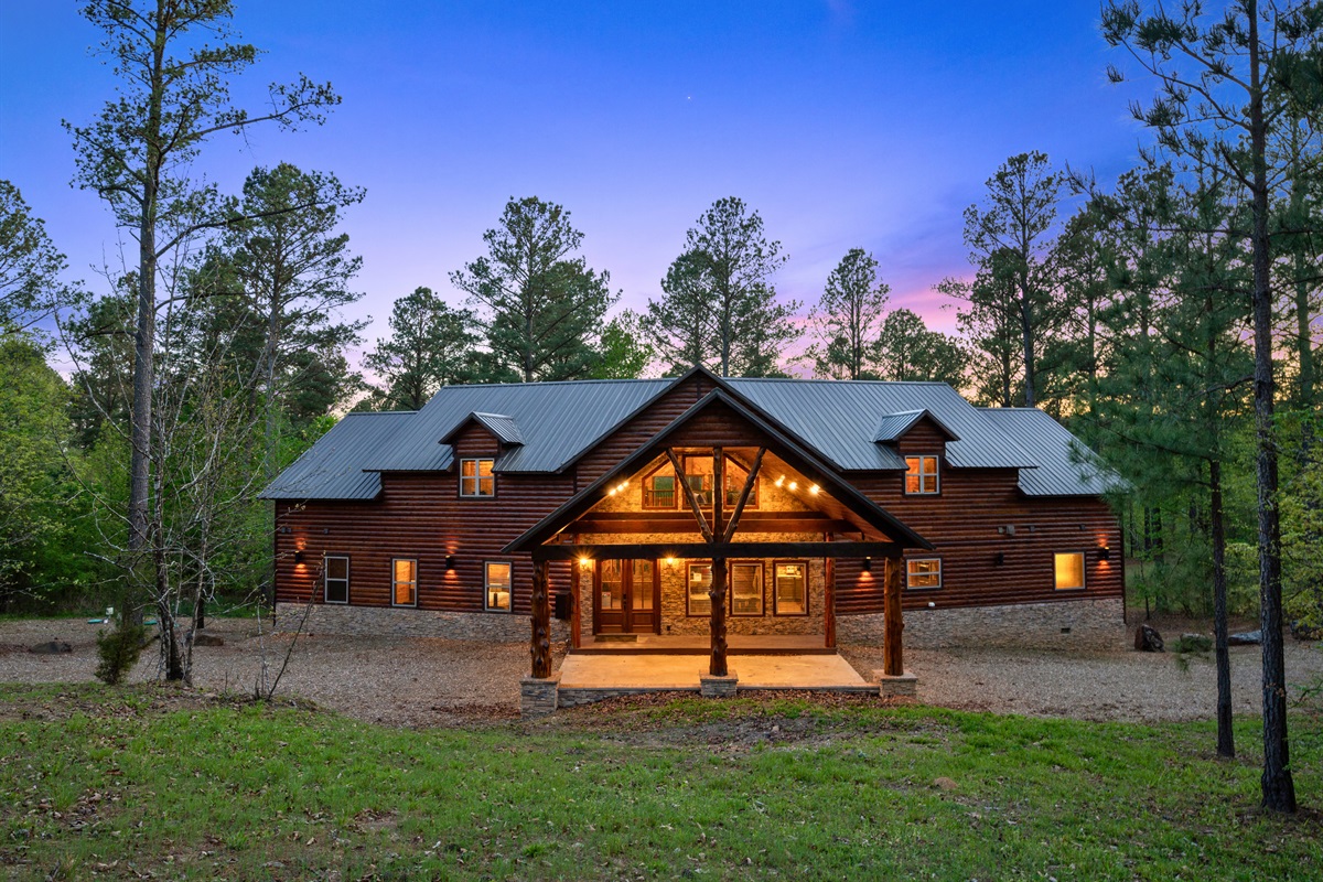 Another angle of the home highlights its warm lighting and inviting presence, especially as the day transitions into evening.