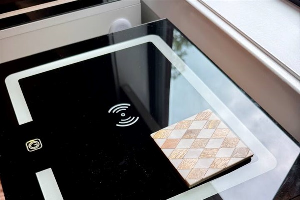 Wireless and lighted nightstands for your electronics in the twin bedroom.