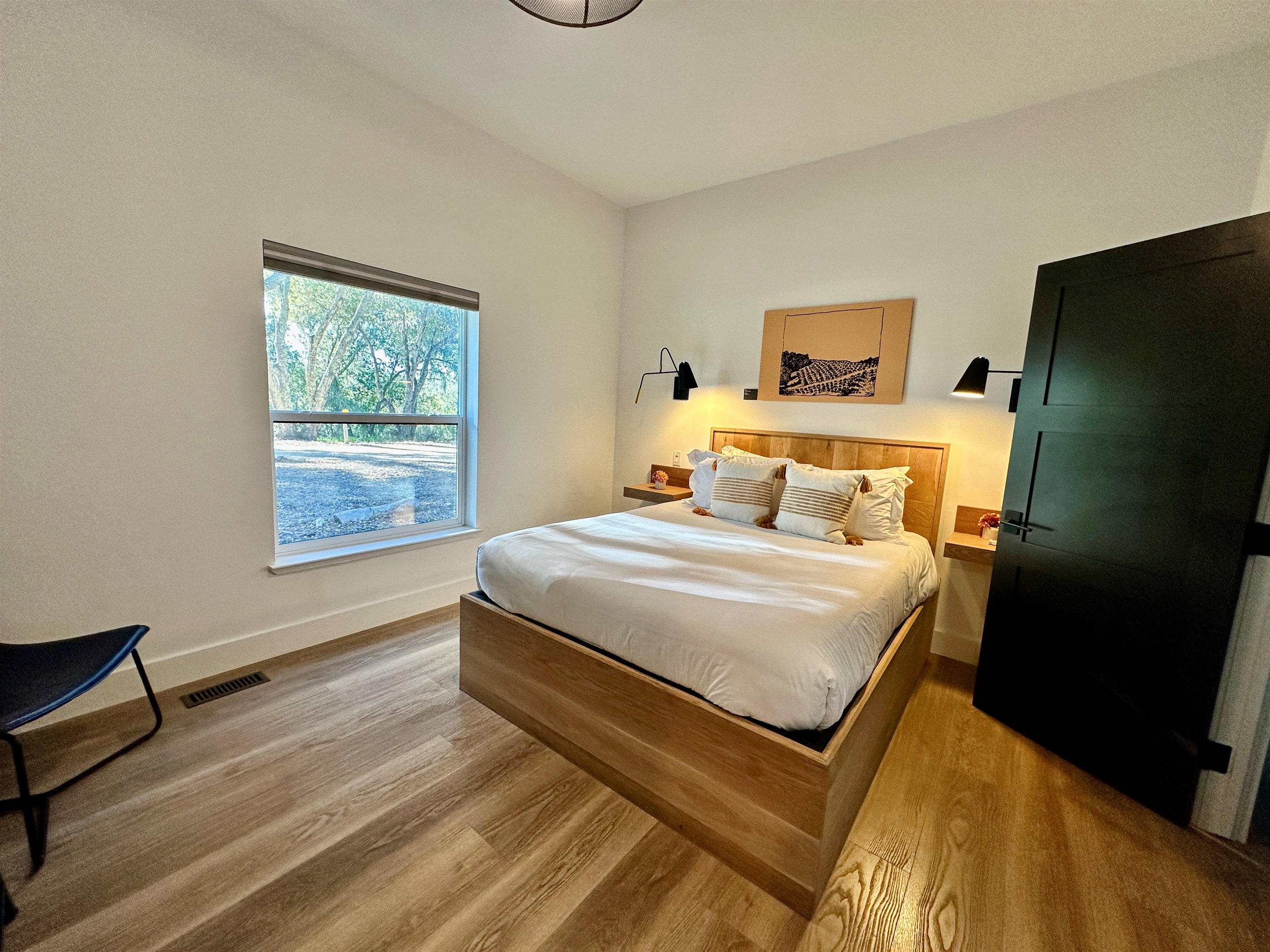 A plush, queen-sized retreat with a view anchored by a puffy mattress for an effortless stay.