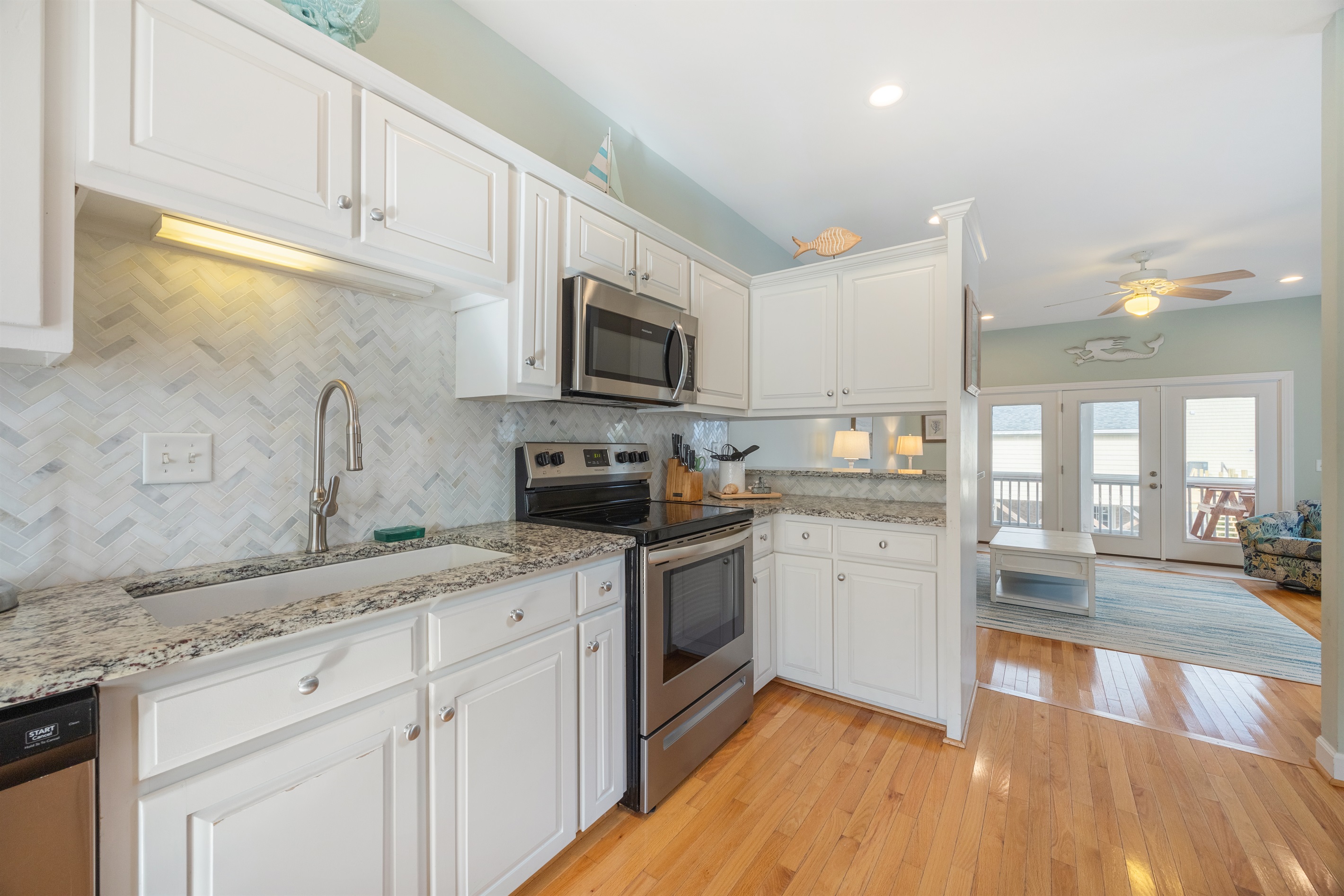 Perfect for entertaining—kitchen overlooks the cozy coastal living room