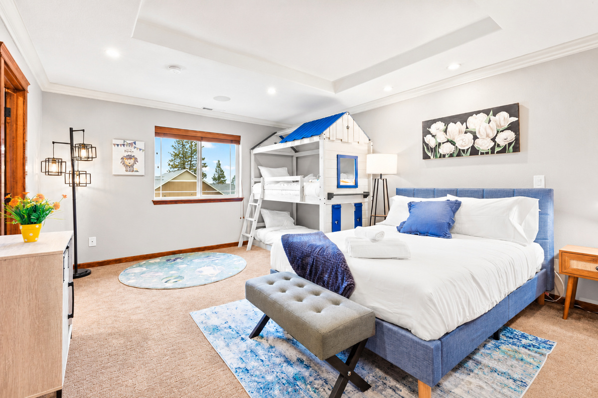 Experience the epitome of family-friendly luxury in our 2ndfloor bedroom. Enjoy the spacious comfort of a queen bed while the kids delight in their playful bunkbeds. With a walk-in closet for added convenience and an ensuite bathroom.