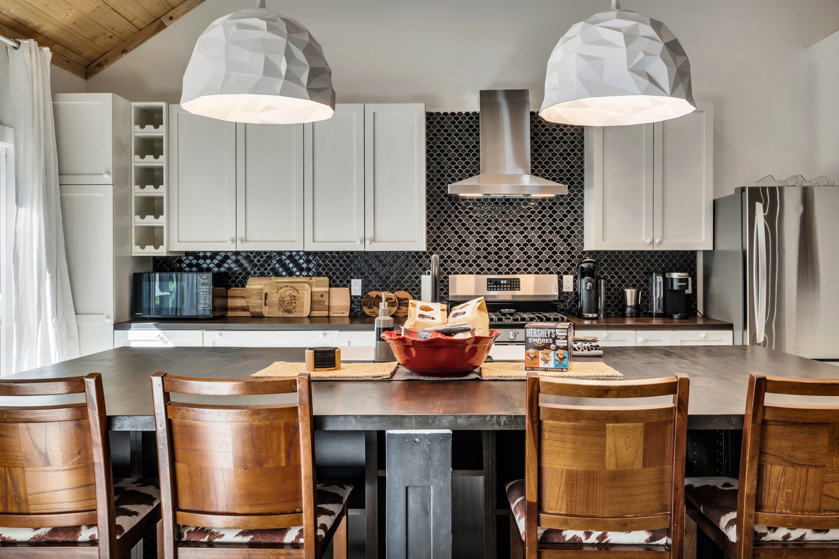 A bright, well-equipped kitchen with a large island makes it easy to cook together, serve a casual breakfast, or gather over snacks and drinks.