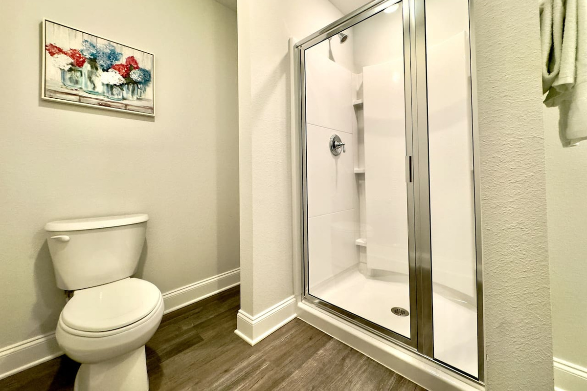 Step behind the glass, warm water rushing over you. Cool tile beneath bare feet, a soft towel waiting nearby. Steam rising, quiet and private.