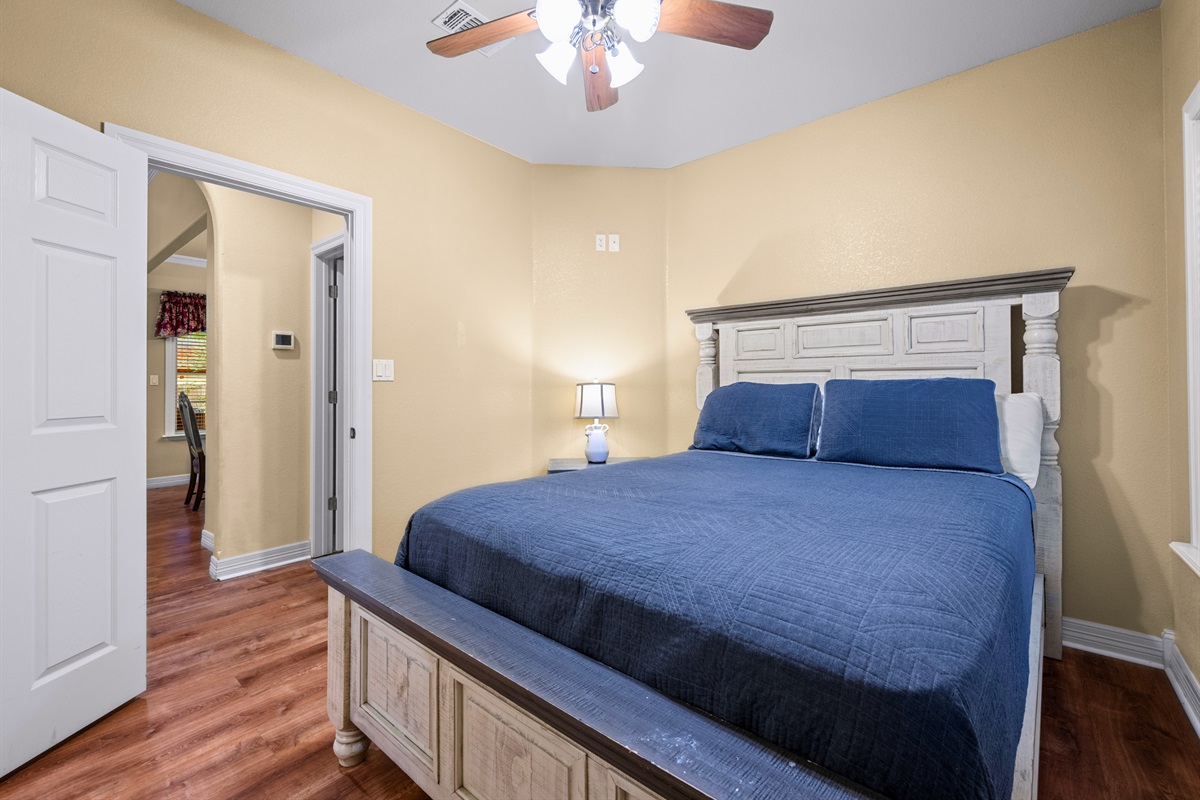 Comfortable queen bedroom with neutral tones.
