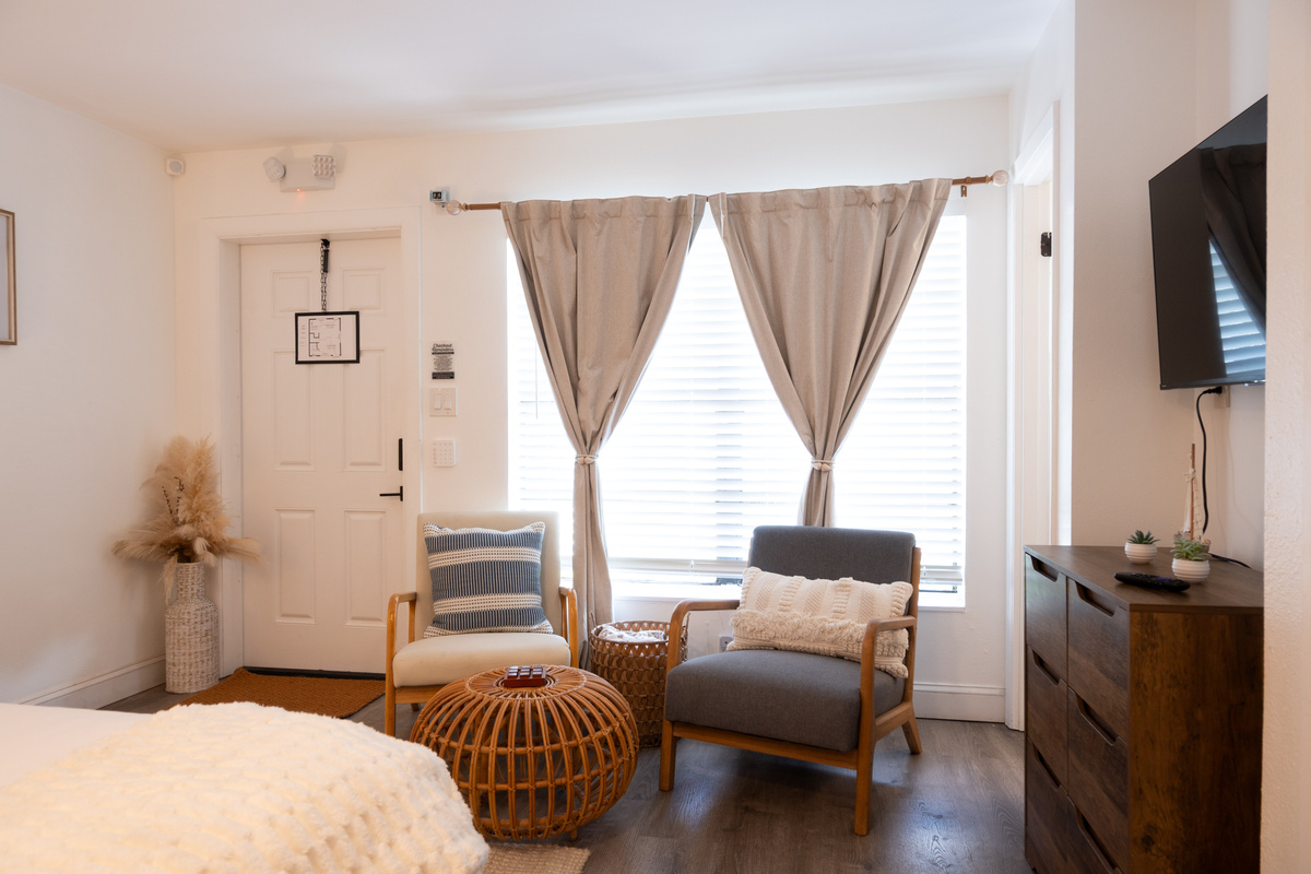 Cozy sitting area with armchairs, rattan accents and Smart TV