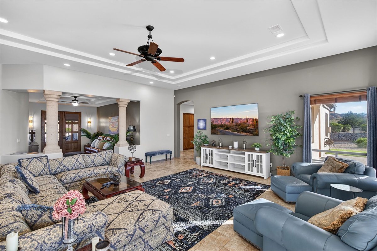 Open-concept great room with high ceilings, Smart TV, and comfortable group seating designed for relaxing together