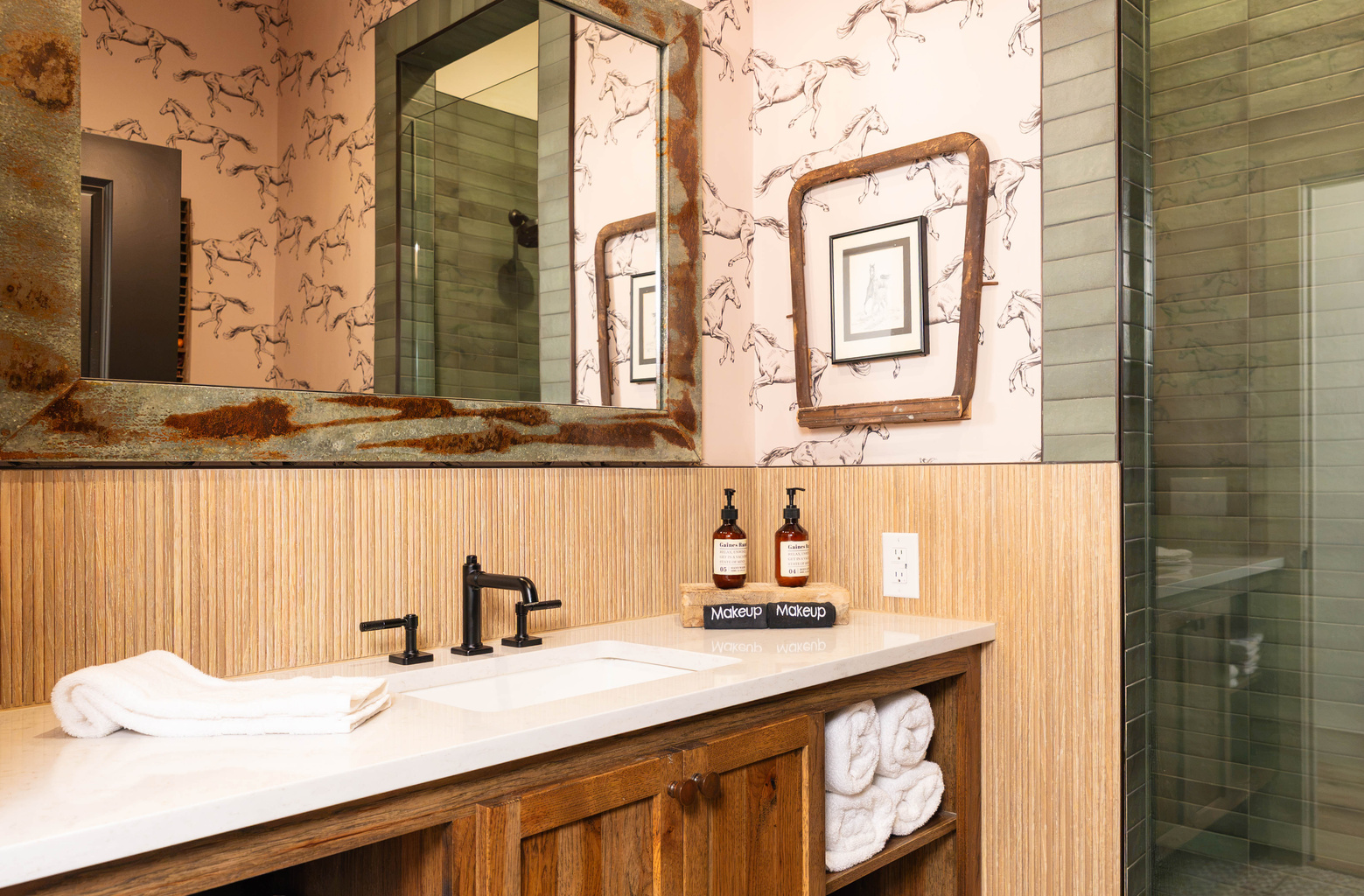 Private en-suite bathroom at Rancher's Rest — designer vanity, walk-in tile shower, and modern Western finishes at Gaines Ranch on the Square.