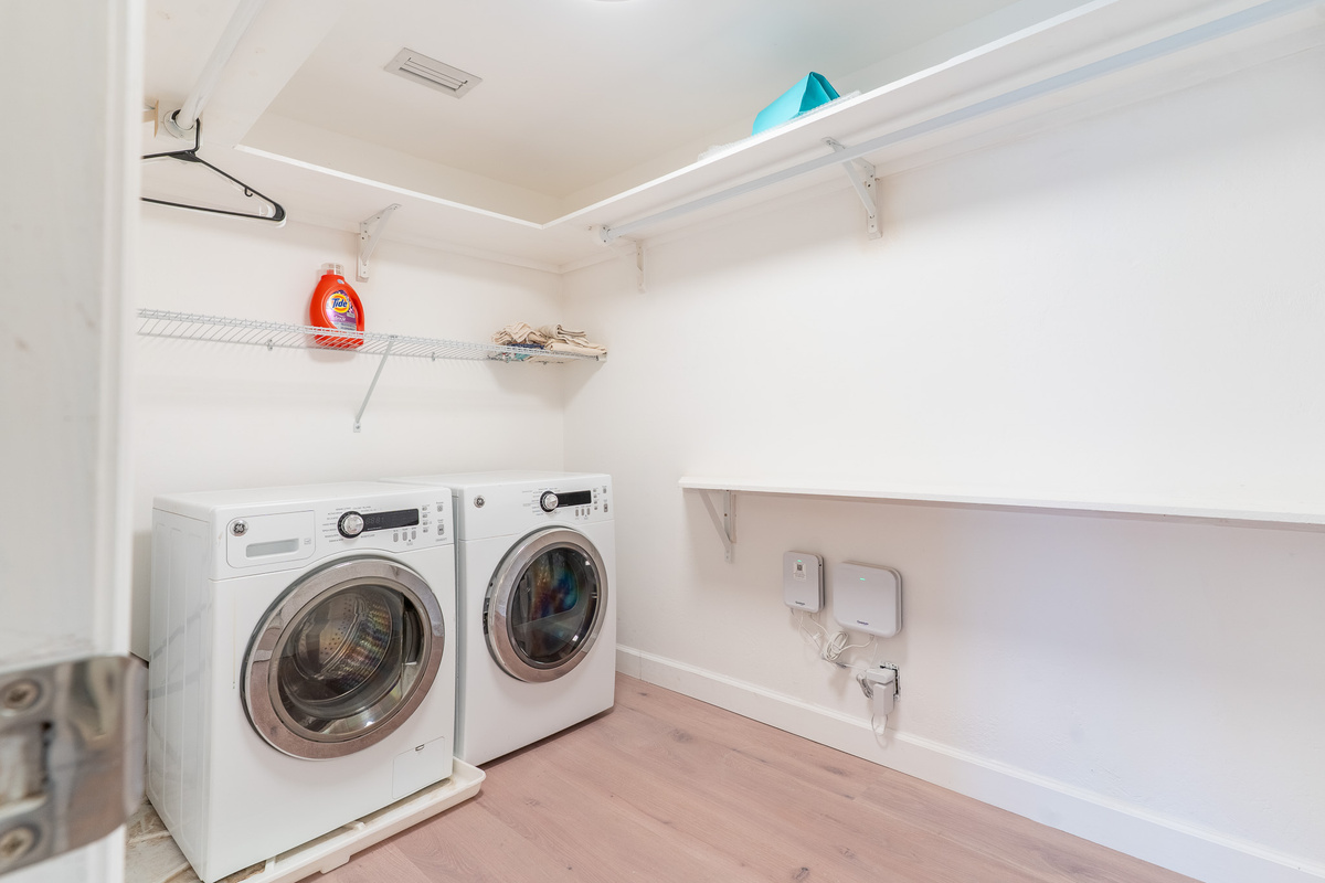Primary room closet with laundry machines.