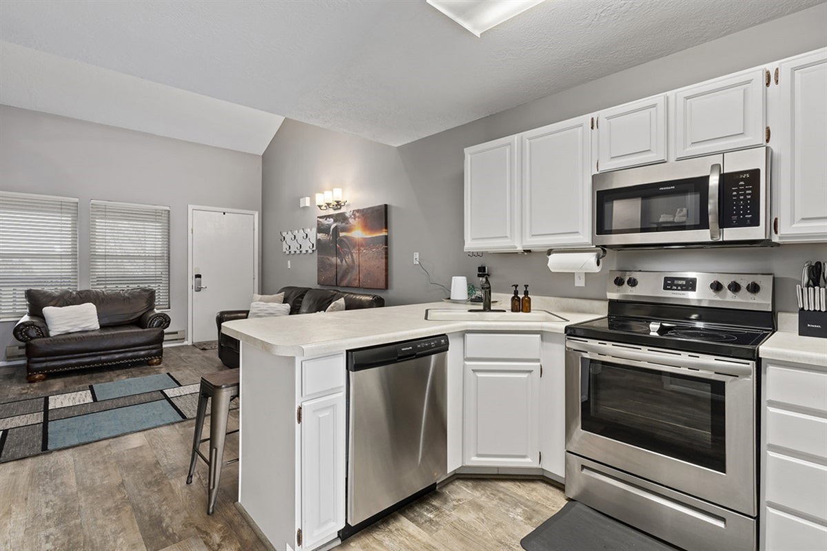 Bright, modern kitchen with stainless appliances—cook, dine, and connect with ease.