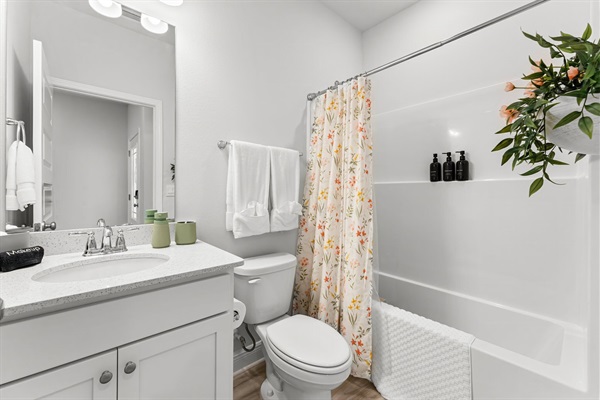 This floral bathroom has all toiletries you need and is shared between the bunk and coral rooms