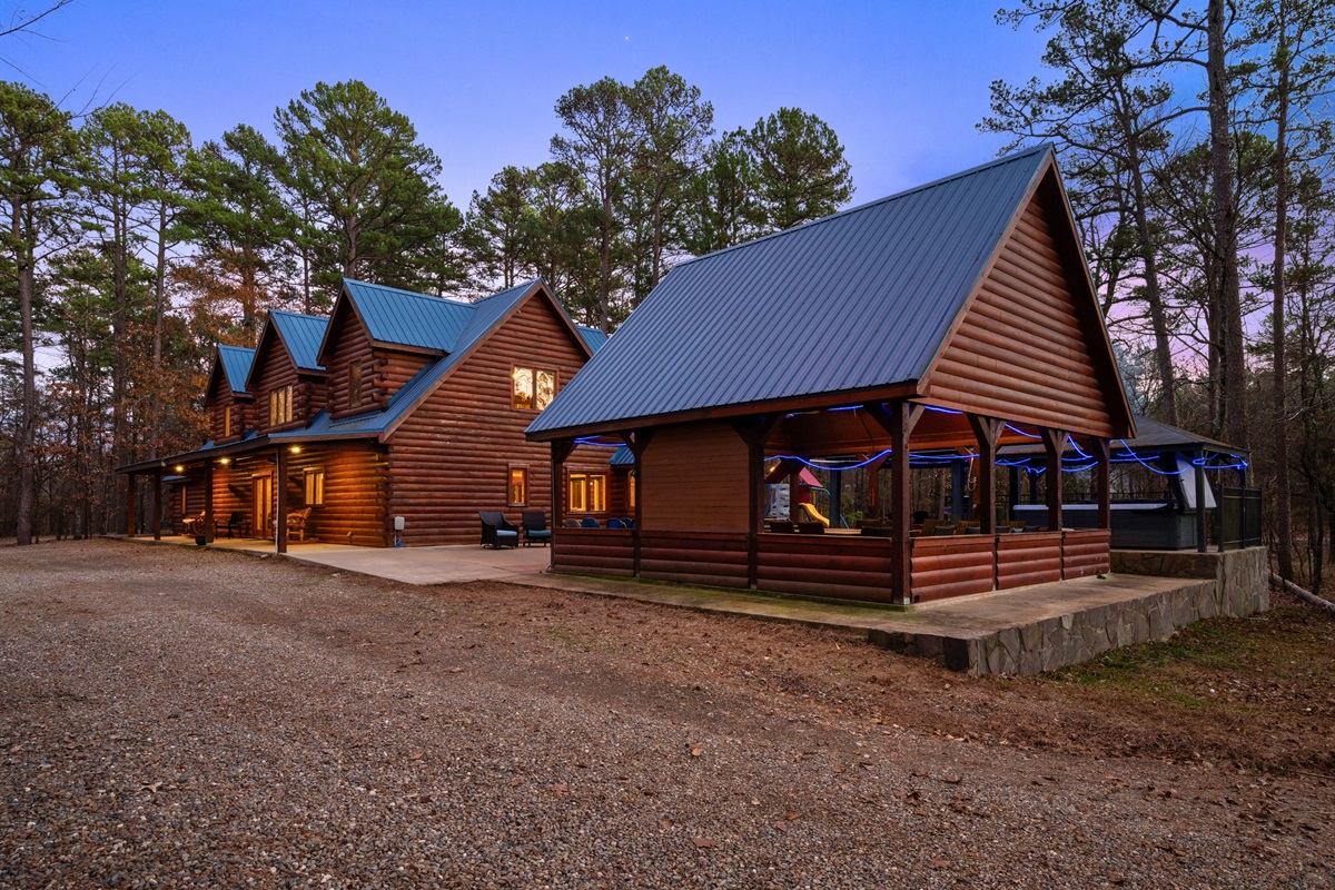 This view highlights both the main cabin and nearby outdoor gathering areas designed for shared experiences.