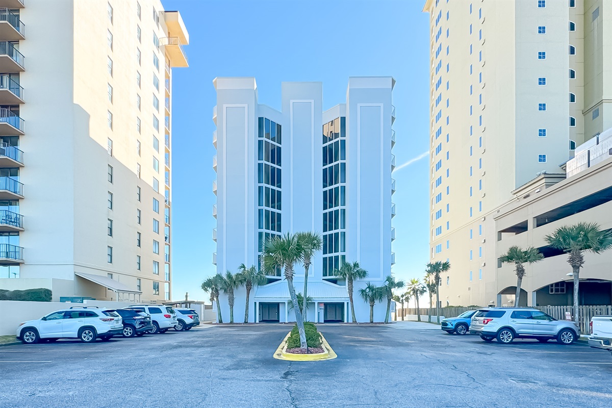 Soaring architecture against a backdrop of clear blue skies and swaying palm trees. Experience the allure of beachfront living.