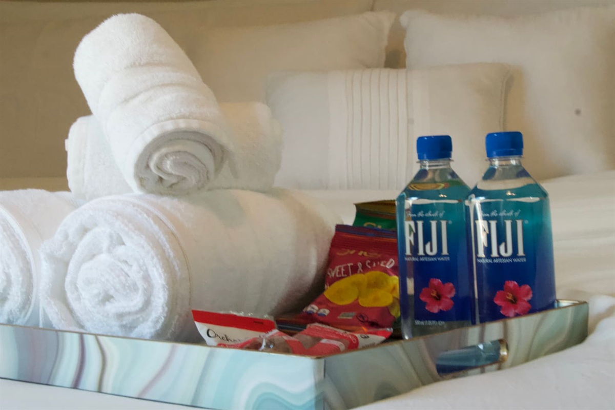Hotel-style welcome touches with fresh towels and bottled water.