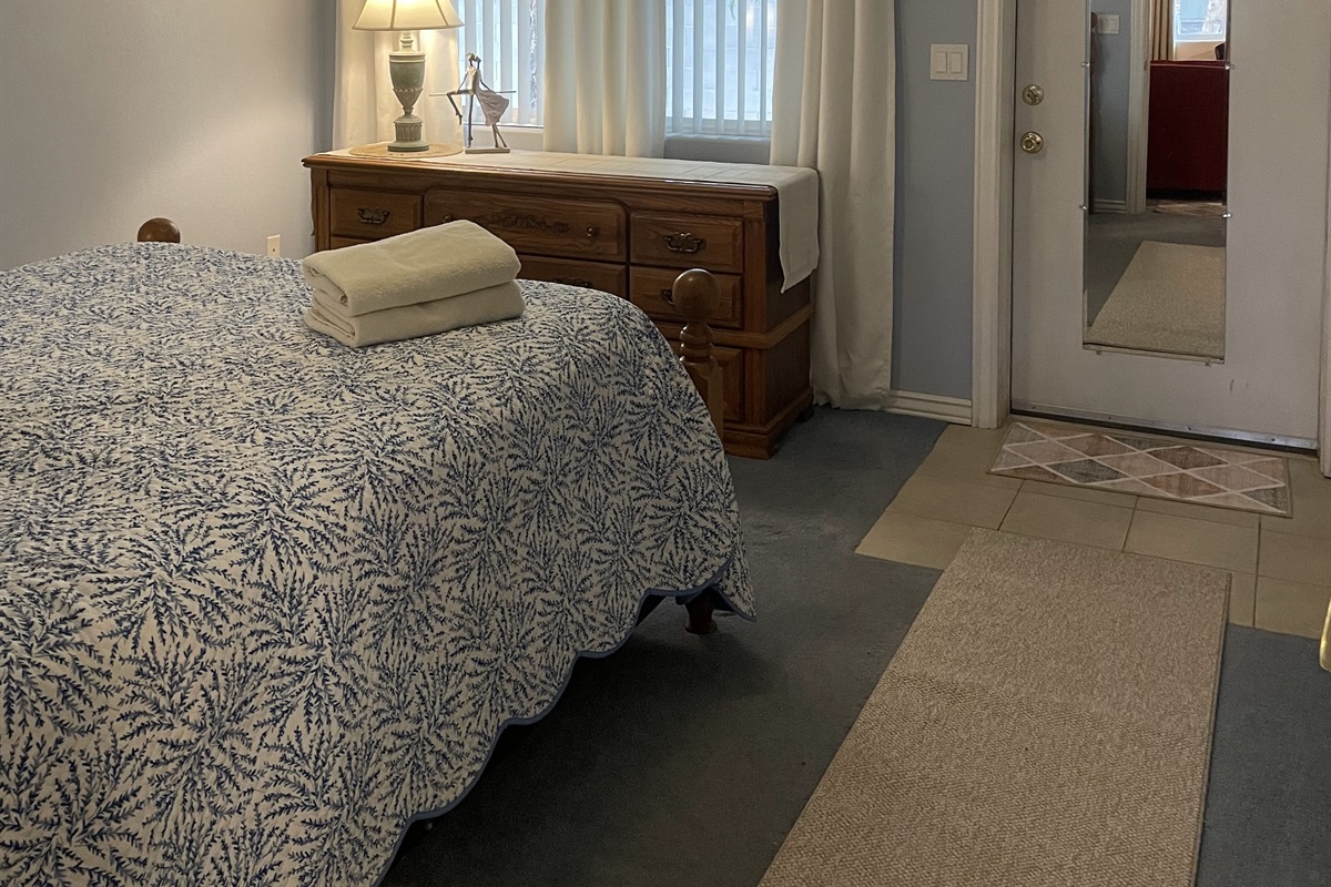 Settle into this comfortable bedroom with soft tones, a cozy bed, and convenient access to the ensuite—your perfect space to relax and recharge.