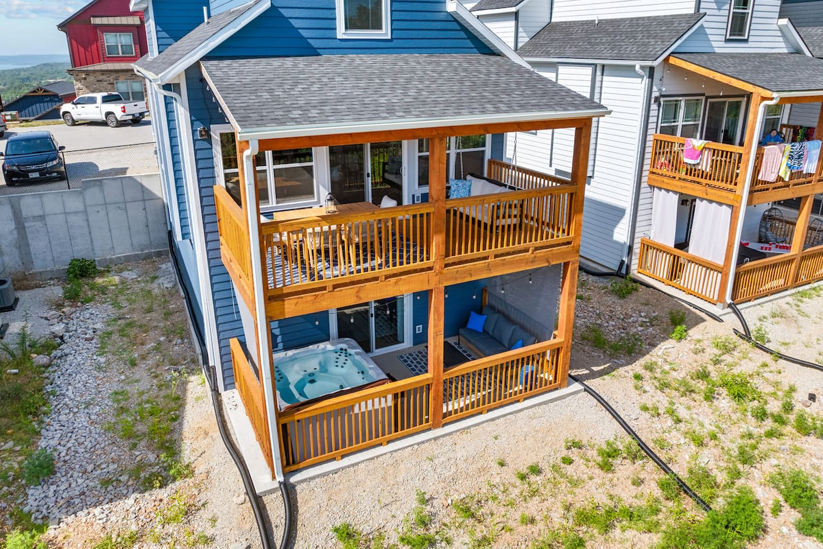 Relax after a long day in our 2 fenced in areas with private hot tub, dining area, and swinging bench.