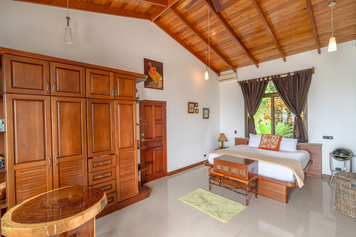 King bedroom suite with carved wood furnishings and soaking tub