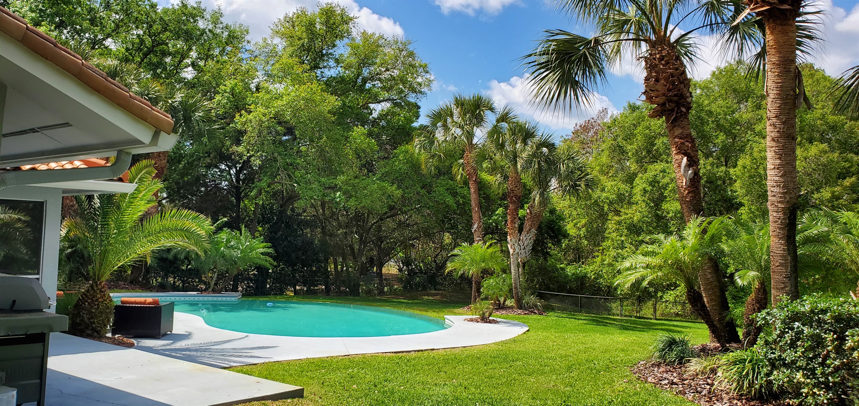 View of pool and fenced in backyard
