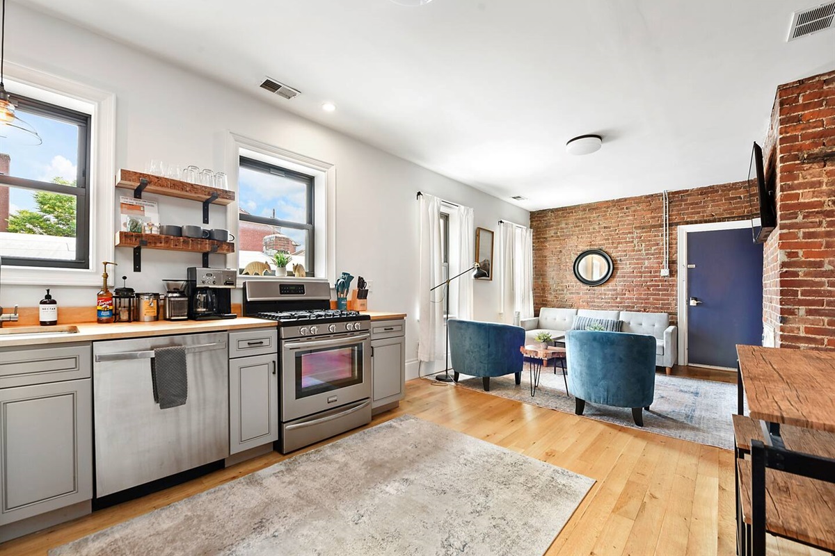 Fully equipped kitchen featuring modern design and sleek stainless steel appliances — ready for all your cooking needs.