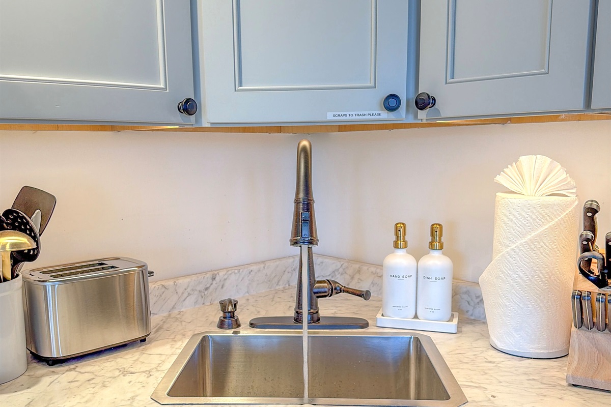 Featuring: oven, electric stove top, utensils, hand soap, dish soap, glassware, bakeware, quality knives, & more.