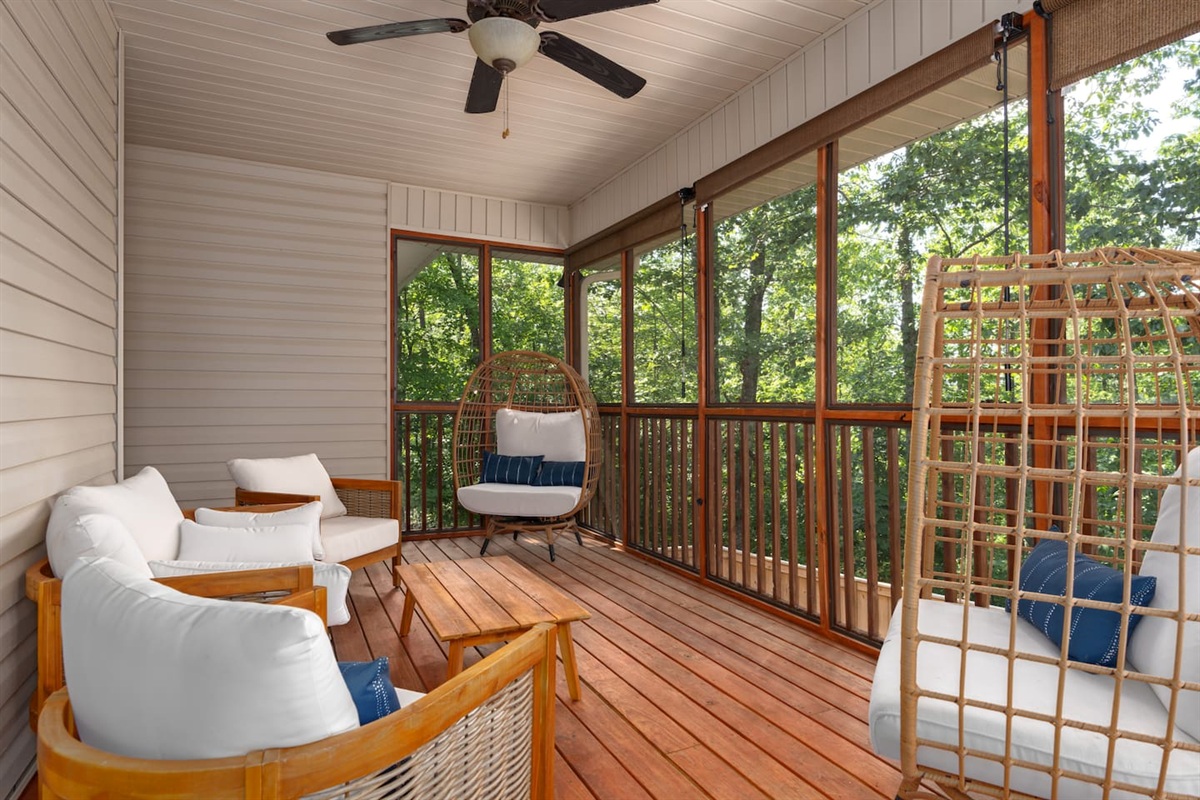 Upstairs screened porch with roll down shades, refreshment table, and fun swivel chairs.  The perfect Instagram space for photos with friends and family