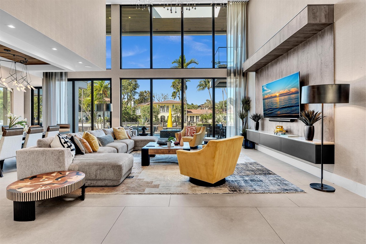 Spacious luxury living room with upscale décor, generous seating, and large Smart TV — ideal for group stays and elevated entertaining.