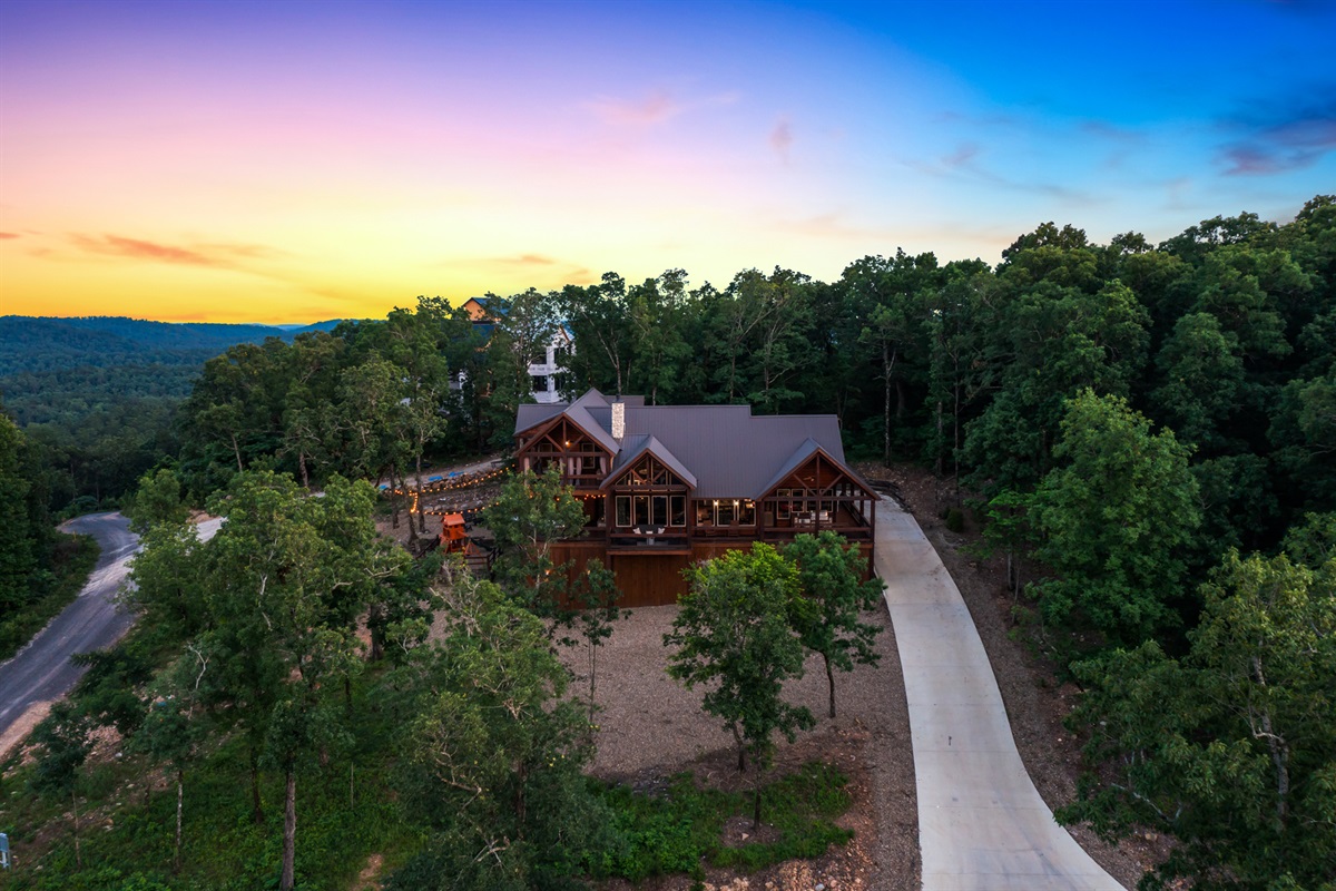 Scenic aerial sunset view of the cabin surrounded by peaceful forest landscapes