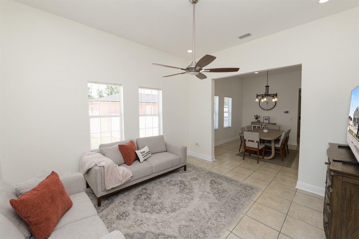 Vaulted ceilings and abundant windows elevate the space, while modern furniture adds function and flair.