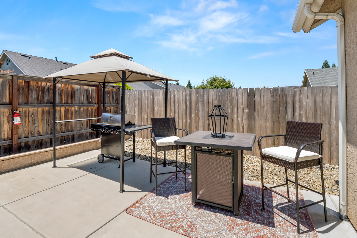 Fire up the grill and enjoy outdoor dining in this private backyard retreat. Featuring a covered BBQ station and comfortable seating area, it's the perfect place to gather with family and friends for meals under the open sky.