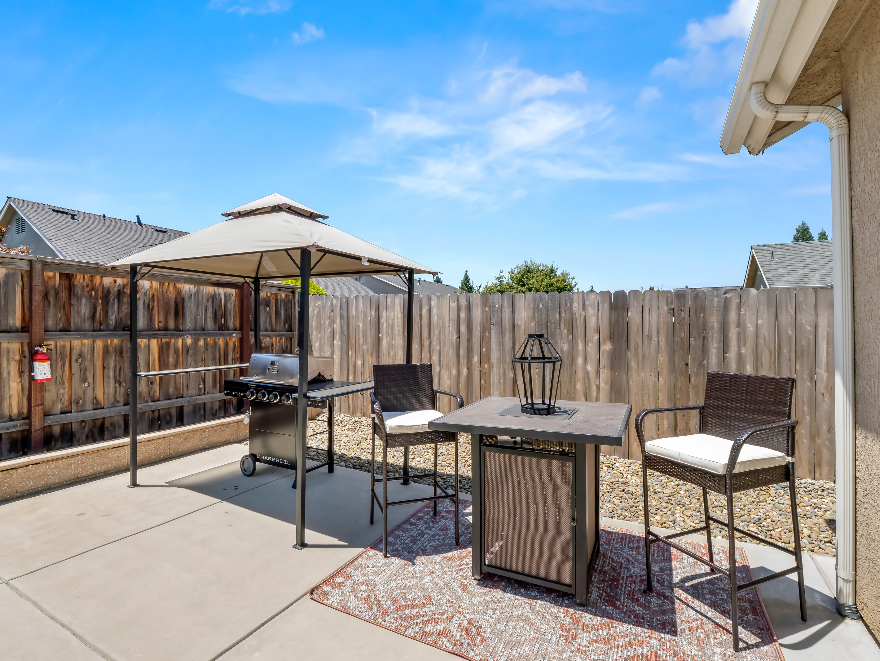 Fire up the grill and enjoy outdoor dining in this private backyard retreat. Featuring a covered BBQ station and comfortable seating area, it's the perfect place to gather with family and friends for meals under the open sky.