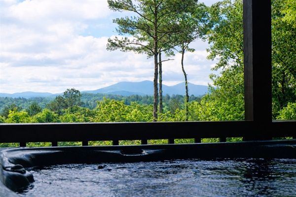 Relax in the hot tub located on the main level deck with breathtaking mountain views. 