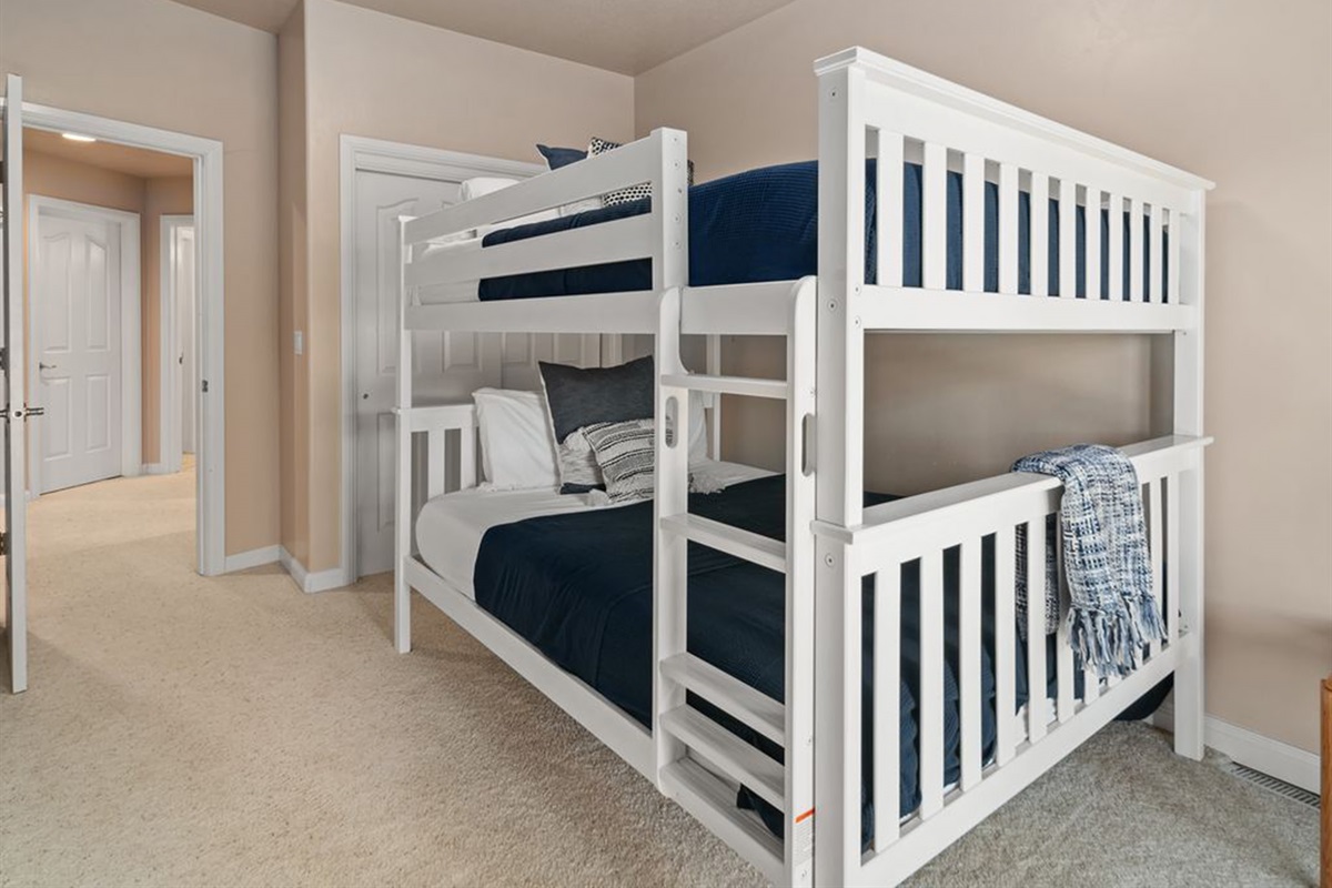 Fun and functional bunk room with queen-over-queen beds—ideal for groups or families.