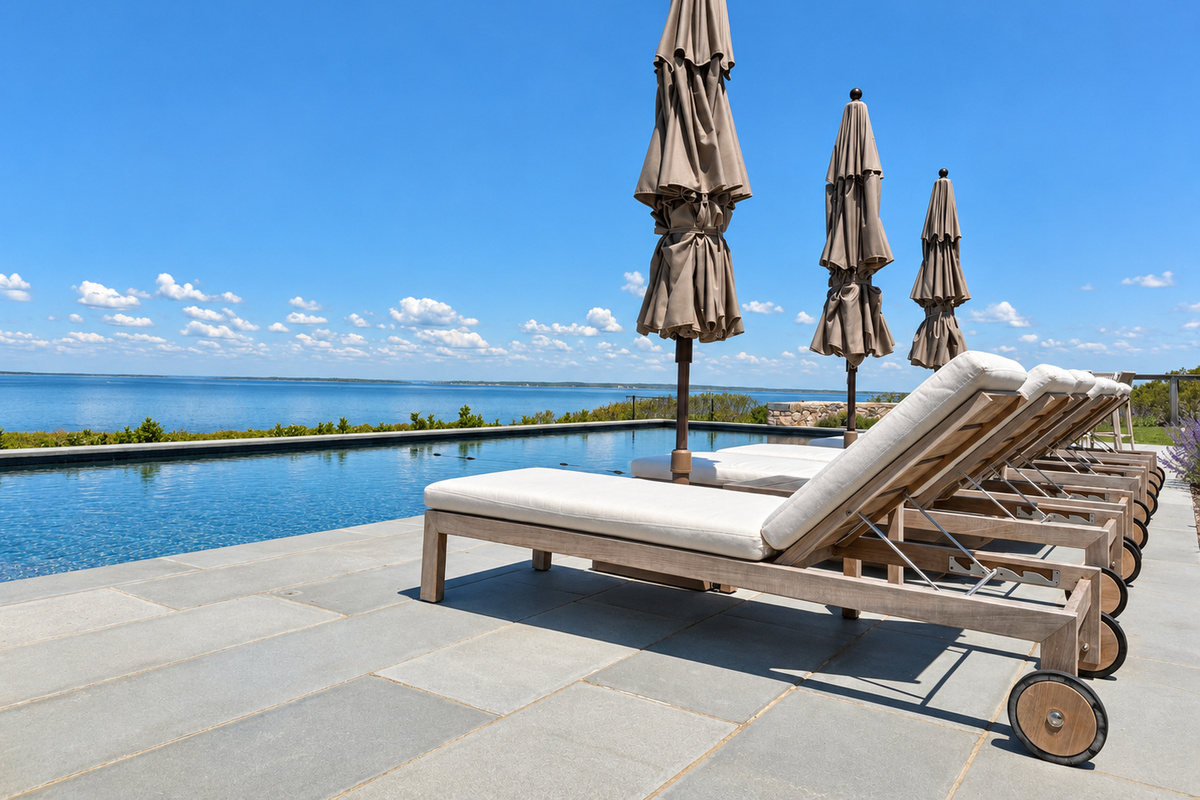 Poolside lounge chairs with umbrellas
