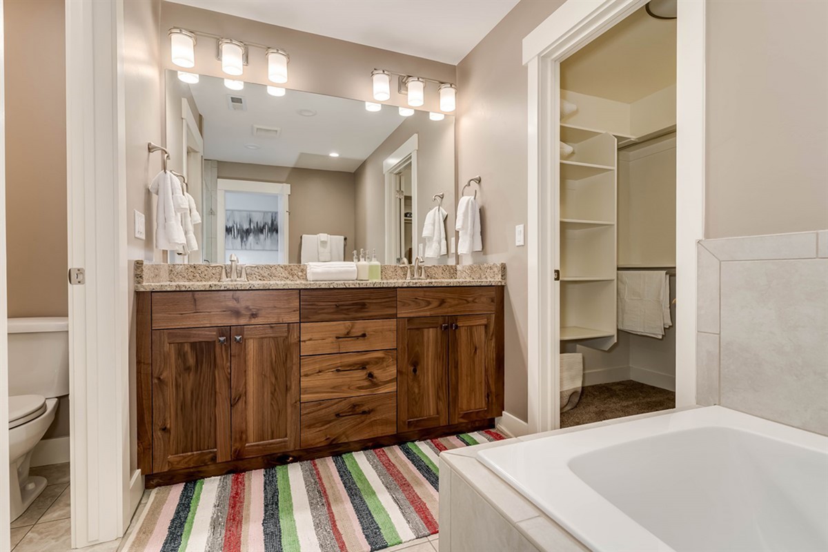 Spa-inspired primary bathroom with soaking tub and elegant finishes