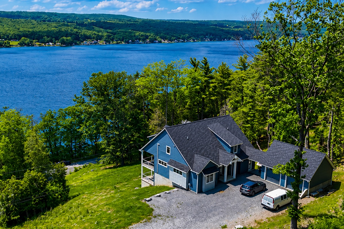 Perched above the water, enjoy breathtaking lake views from nearly every room of this hilltop haven 🌊🏞️